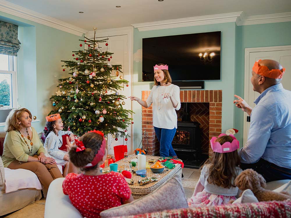 Family playing charades at Christmas