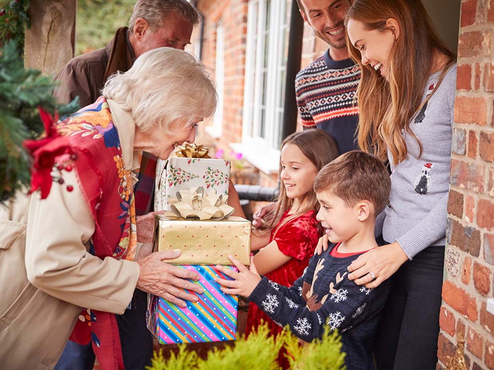 Grandparents giving gifts to their grandchildren.