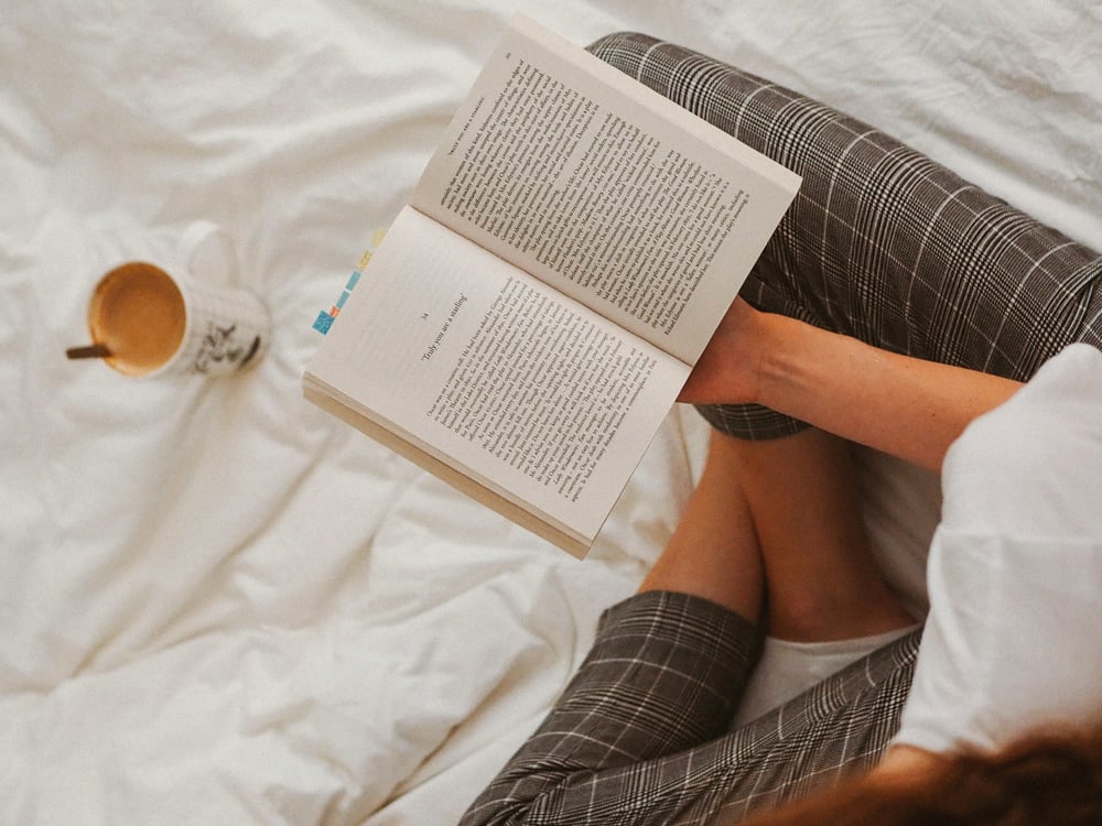 Mom reading a book and enjoying coffee on Mother's Day.