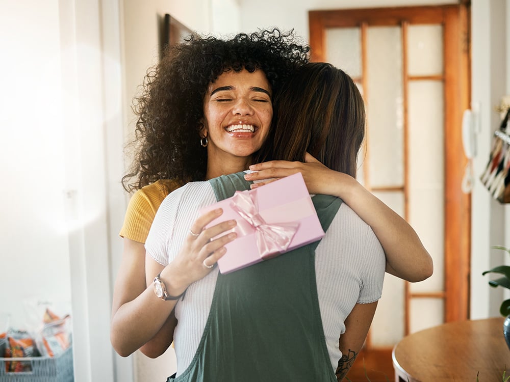Woman accepting a gift and saying thank you with a hug.